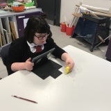 Photograph of a pupil making an animation movie using a school iPad and the Stickbot app