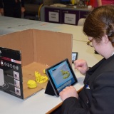 Photograph of a pupil making an animation movie using a school iPad and the Stickbot app