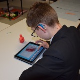 Photograph of a pupil making an animation movie using a school iPad and the Stickbot app