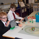 Photograph of two  pupils  making an animation movie using a school iPad and the Stickbot app