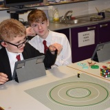 Photograph of two  pupils  making an animation movie using a school iPad and the Stickbot app