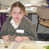 Picture of a pupil with the clay butterfly they made