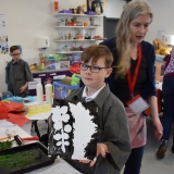 Picture of a pupil holding his finished print art work