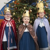 Photograph of  pupils dressed as the three kings beside the Chritsmas tree