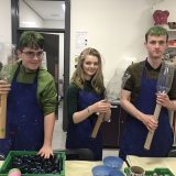 Picture of three pupils working in the Art room during Hallow Green day