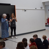 Picture of the Lord Lieutenant of Antrim signing to school pupils