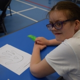 Photograph of a pupil discussing and writing down what made her  feel stressed or ‘down’