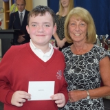 Photograph of a pupil after receiving their prize  from the special guest