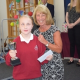 Photograph of a pupil after receiving their prize  from the special guest