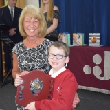 Photograph of a pupil after receiving their prize  from the special guest