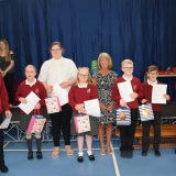 Group photograph of the pupils moving to the secondary department next year after each receiving a gift from the special guest