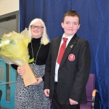 Photograph of Ms Rosaleen Dempsye and a pupil after receiving a bouquet of flowers  form the school