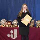 Photograph ofa pupil with their examination certificates