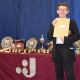 Photograph ofa pupil with their examination certificates