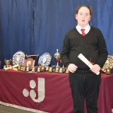 Photograph of a pupil with their character award certificate