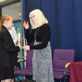 Photograph of Ms Rosaleen Dempsye and a pupil with their character award certificate