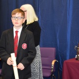 Photograph of a pupil with their character award certificate