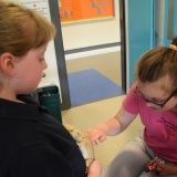 Photograph of pupils holding and petting owls and snakes.