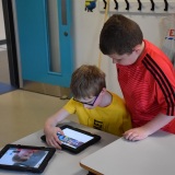 Photograph of pupils working on a iPad