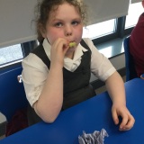 Photograph of a pupil tasting different fruit