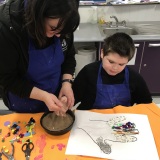 Photograph of a pupil taking part in a tactile art workshop