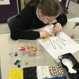 Photograph of a pupil taking part in a tactile art workshop