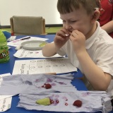 Photograph of a pupil tasting different fruit