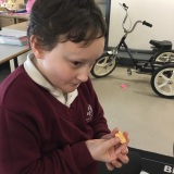 Photograph of a pupil tasting different fruit