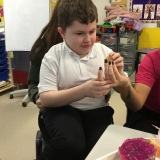 Photograph of a pupil tasting different fruit