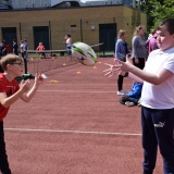 Photograph of two pupils passing a rugby ball to each other