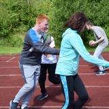 Photograph of a pupil running with a staff member during a game of tag rugby