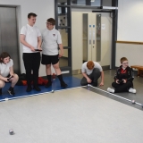 Photograph of  pupils controling   several sphere shaped  robot with iPads