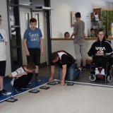 Photograph of  pupils controlling  several sphere shaped  robot with iPads