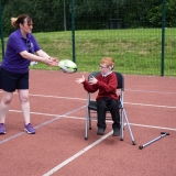 Photograph of a staff member throwing a rugby ball to a pupil