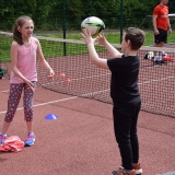 Photograph of two pupils passing a rugby ball to each other